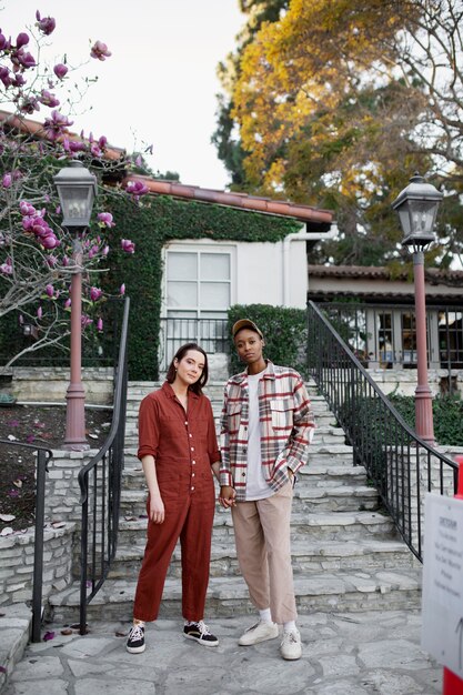 Trans couple posing and holding hands on the city streets