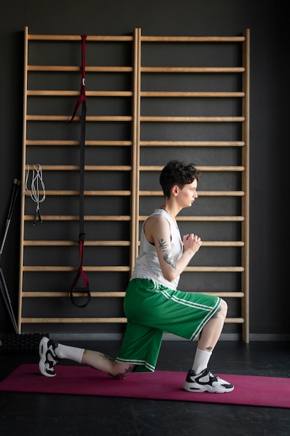 Trans man working out and exercising at the gym