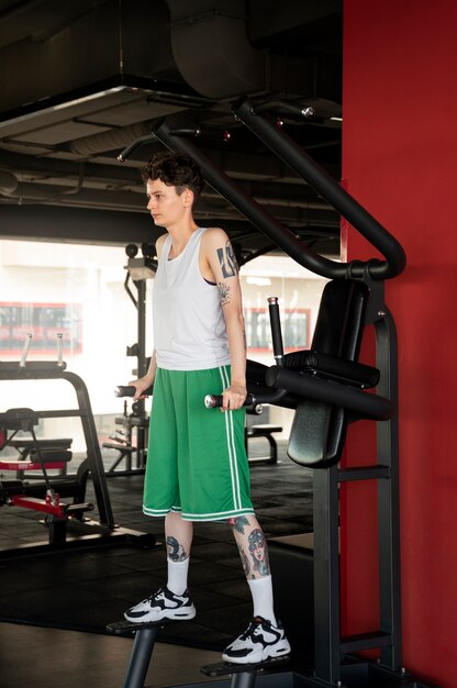 Trans man working out and exercising at the gym