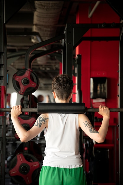 Free photo trans man working out and exercising at the gym