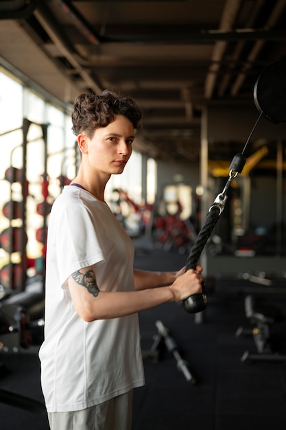 Free photo trans man working out at the gym