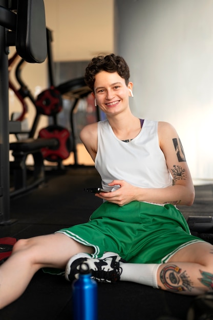 Free photo trans man working out at the gym