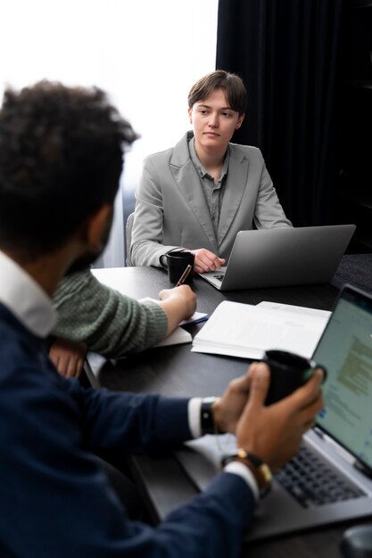 Trans person working at office with colleagues