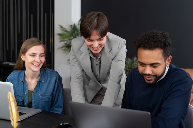 Trans person working at office with colleagues