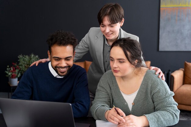 Trans person working at office with colleagues