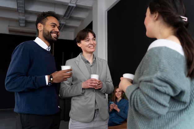 Free photo trans person working at office with colleagues