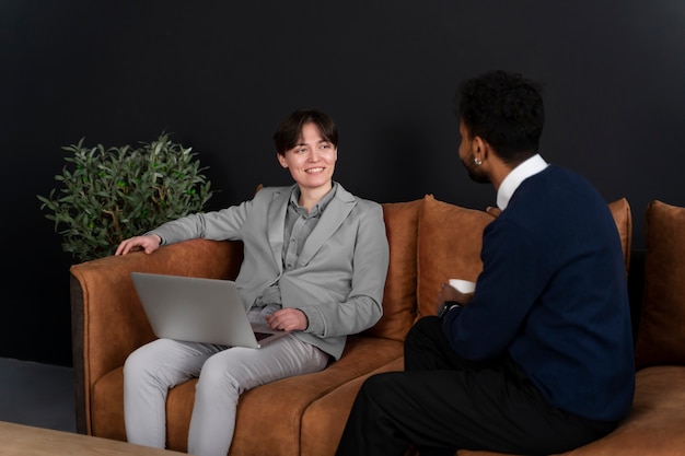 Free photo trans person working at office with colleagues