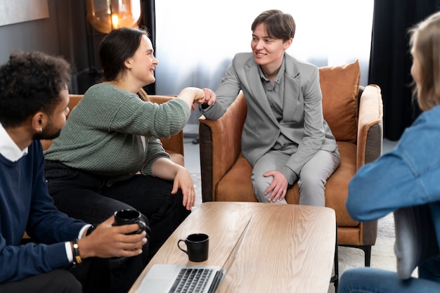 Free photo trans person working at office with colleagues