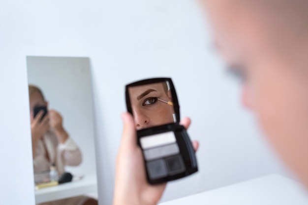 Free photo transgender applying makeup close up