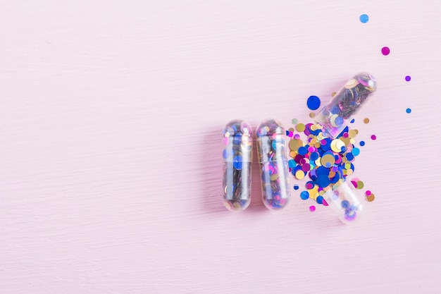 Free photo transparent capsules filled with colorful confetti