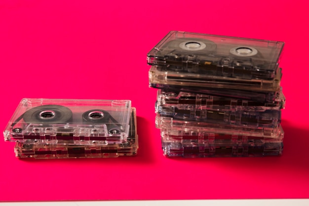 Free photo transparent cassette tapes on red background