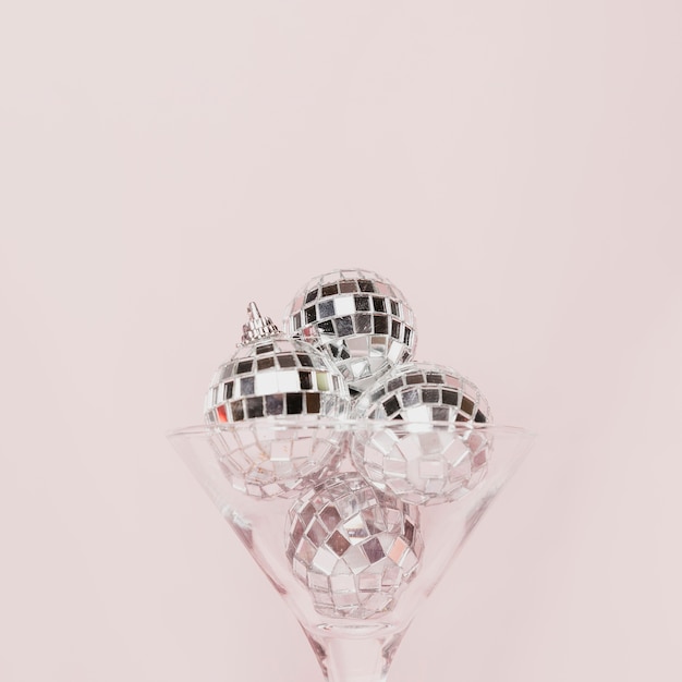 Free photo transparent champagne glass with disco balls