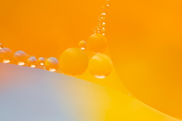 Free photo transparent droplets on watery orange backdrop