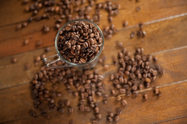 Transparent glass cup filled with coffee beans