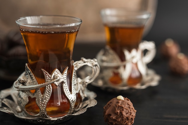 Transparent glasses with tea and truffle