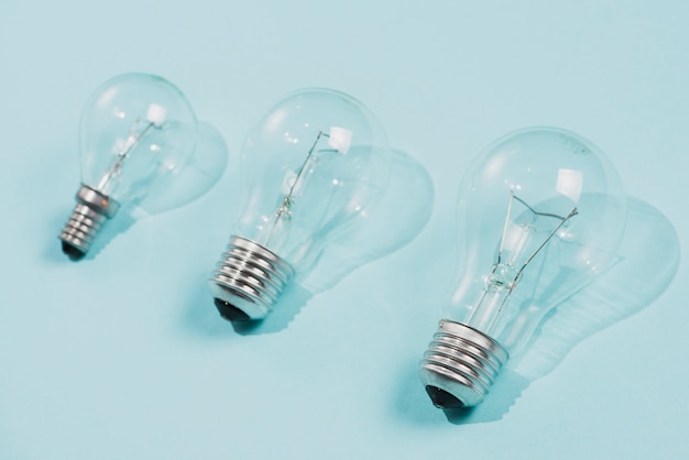 Transparent light bulbs on blue background