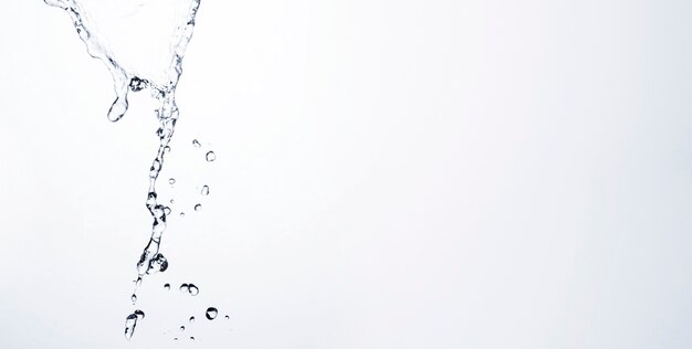 Transparent liquid drops on light background with copy space