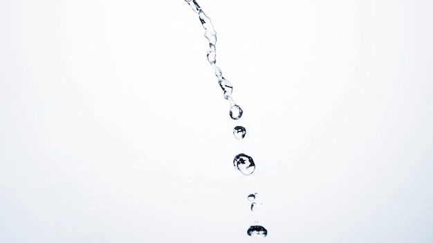 Transparent liquid drops on light background