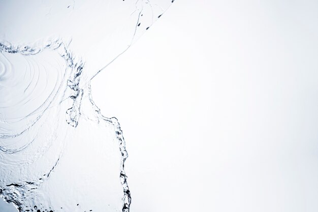 Transparent liquid shape close-up on white background with copy space