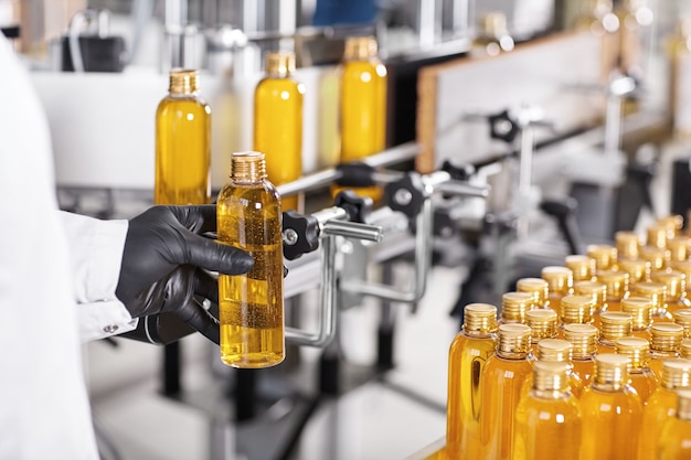 Free photo transparent plastic bottles filled with yellow substance