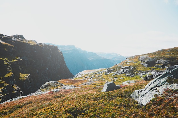 Travel around Norwegian national park at autumn season, hiking in mountains.