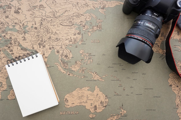 Travel background with blank note and camera