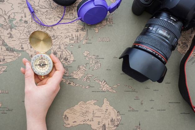 Travel background with hand holding a compass