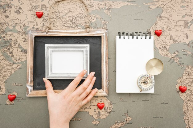 Travel background with hand placing a frame