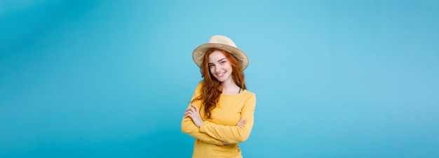 Travel concept close up portrait young beautiful attractive redhair girl wtih trendy hat and sunglas
