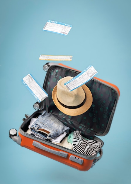 Travel concept with open luggage and tickets