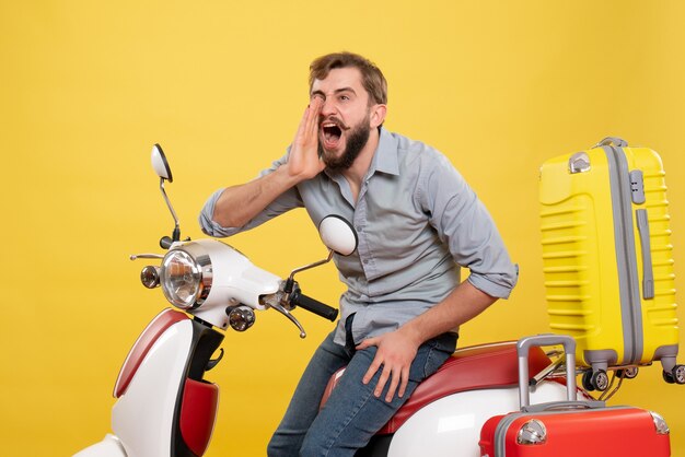 Travel concept with young nervous emotional bearded man sitting on motocycle on it calling someone on yellow 