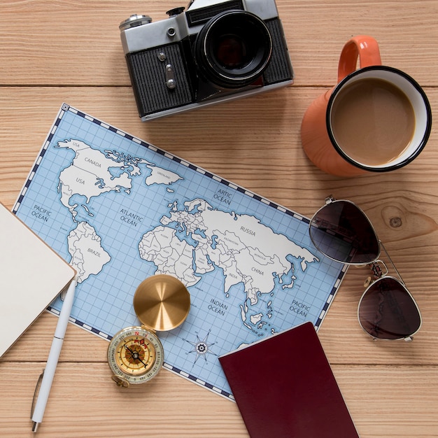 Travel items on wooden background flat lay