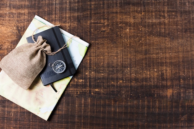 Travel map and accessories on wooden background