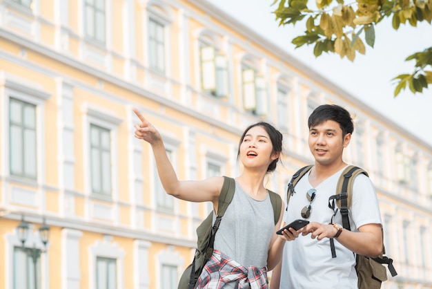 Traveler Asian couple direction on location map in Bangkok, Thailand