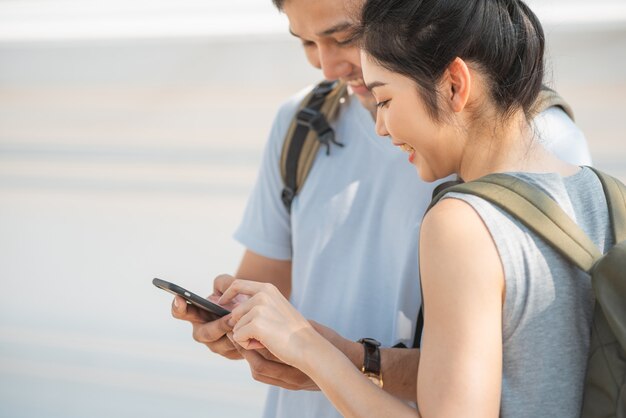 Traveler Asian couple direction on location map in Bangkok, Thailand