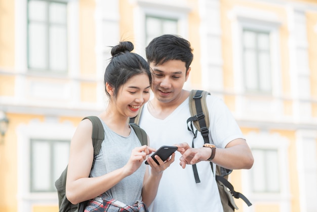 Traveler Asian couple direction on location map in Bangkok, Thailand