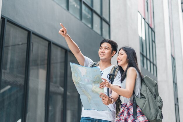 Free Photo traveler asian couple direction on location map in beijing, china