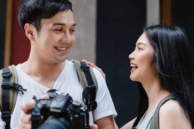 Traveler Asian couple using camera for take a picture while spending holiday trip at Beijing, China