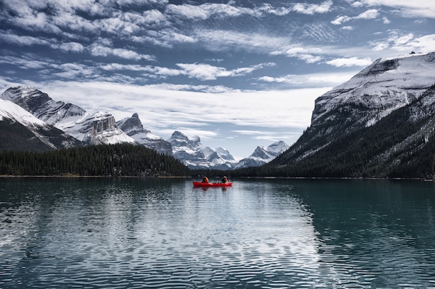 Traveler canoeing on maligne lake with canadian rockies in spirit island at jasper national park