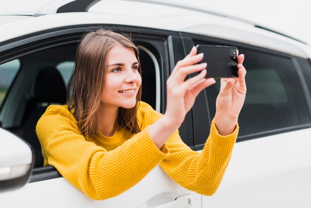 Free photo traveler in car taking a photo