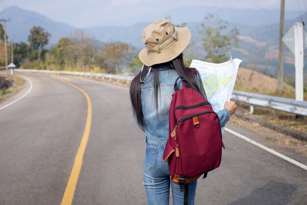 Traveler girl searching right direction on map