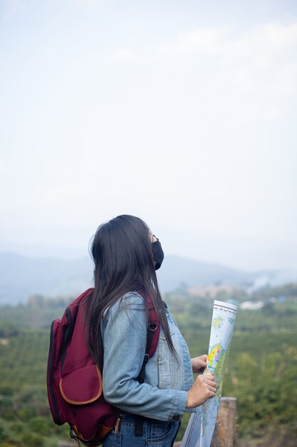 Traveler girl searching right direction on map