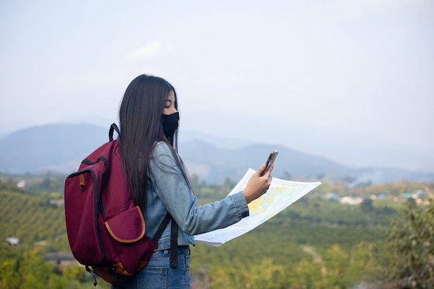 Traveler girl searching right direction on map