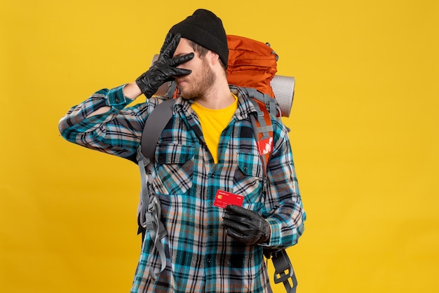 traveler man with backpacker and card holding his head