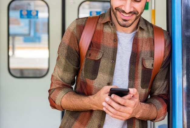 Traveler in metro using phone
