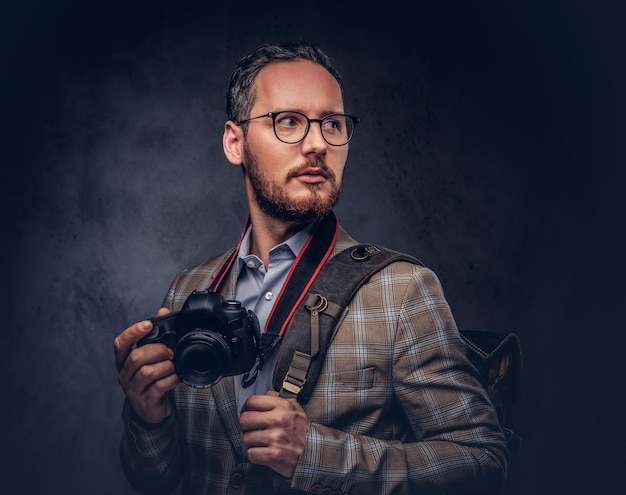 Traveler and photographer. Studio portrait of a handsome bearded