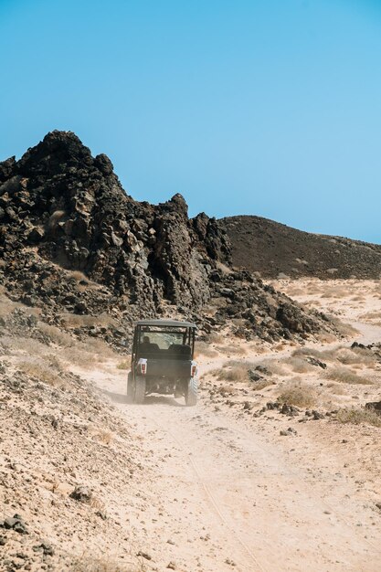 Traveler riding buggy car on beach