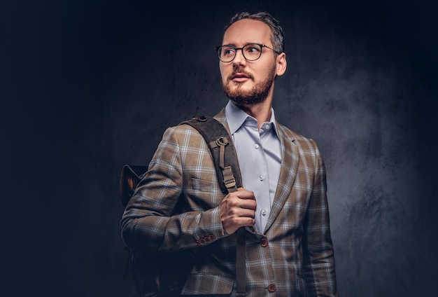 Traveler. Studio portrait of a handsome bearded man wearing a ca