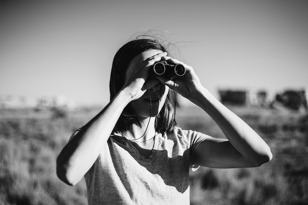 Traveler using binoculars to spot a bird