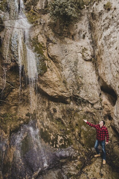 Traveler next to a waterfall